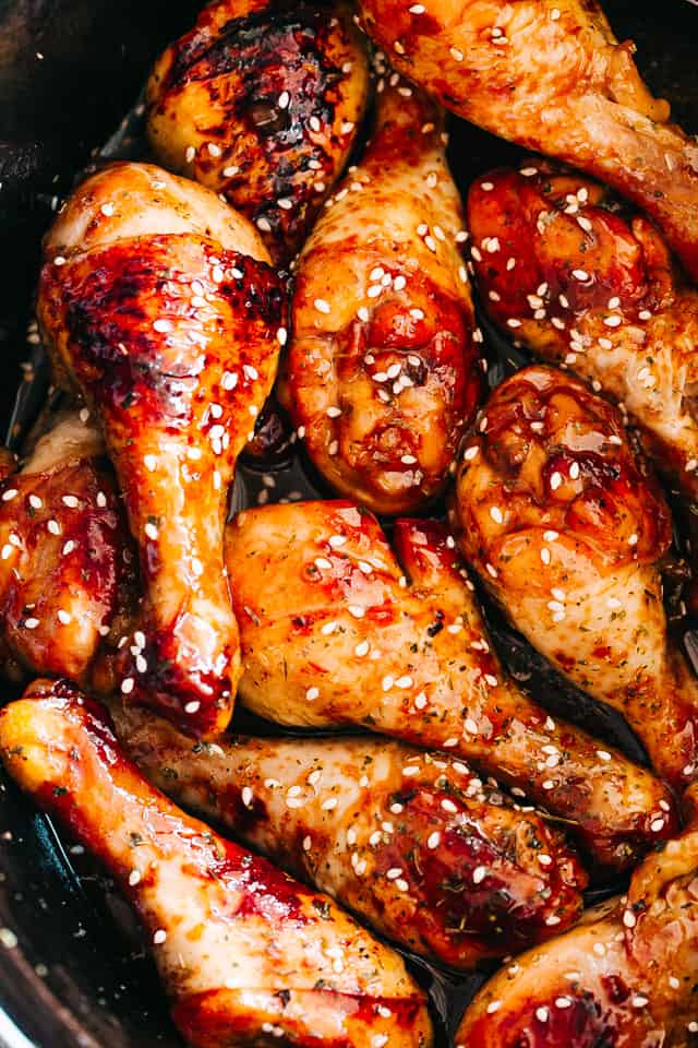 close up of chicken drumsticks glazed with honey sriracha sauce
