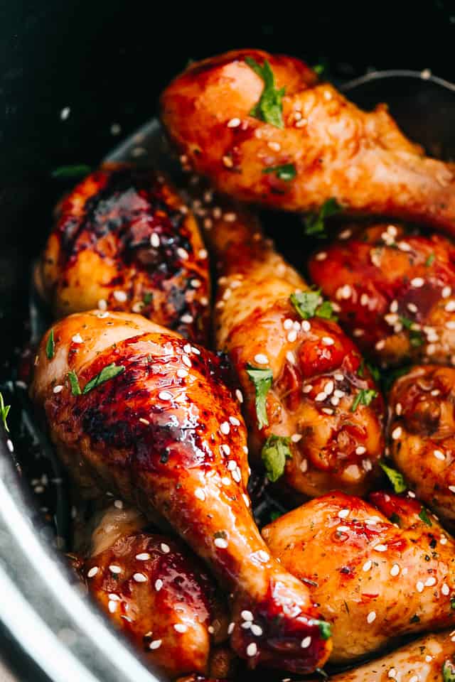 close up of chicken drumsticks glazed with honey sriracha sauce