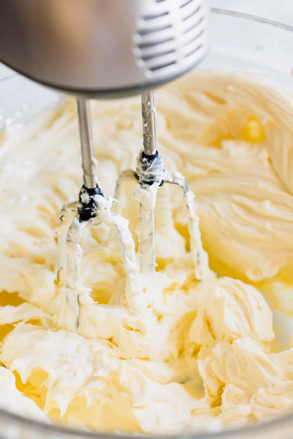 Cream Cheese Frosting Being Beaten with an Electric Stand Mixer