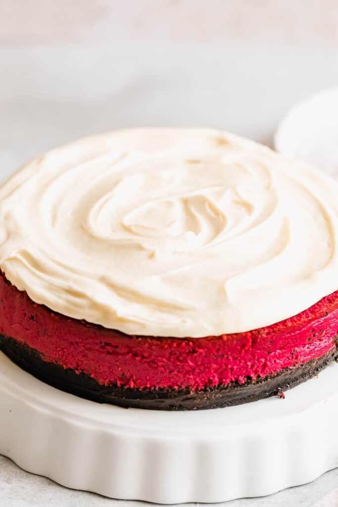A Close-Up Shot of a Red Velvet Cheesecake Frosted with Homemade Cream Cheese Icing