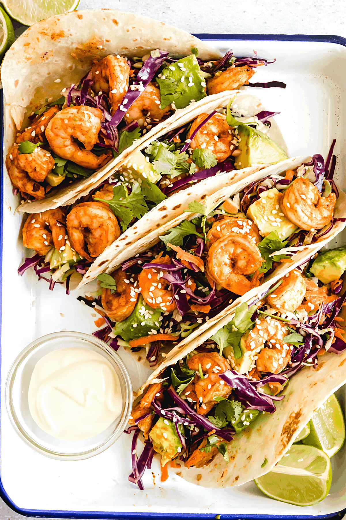 Four Shrimp Tacos Topped with Asian Slaw on a Serving Platter