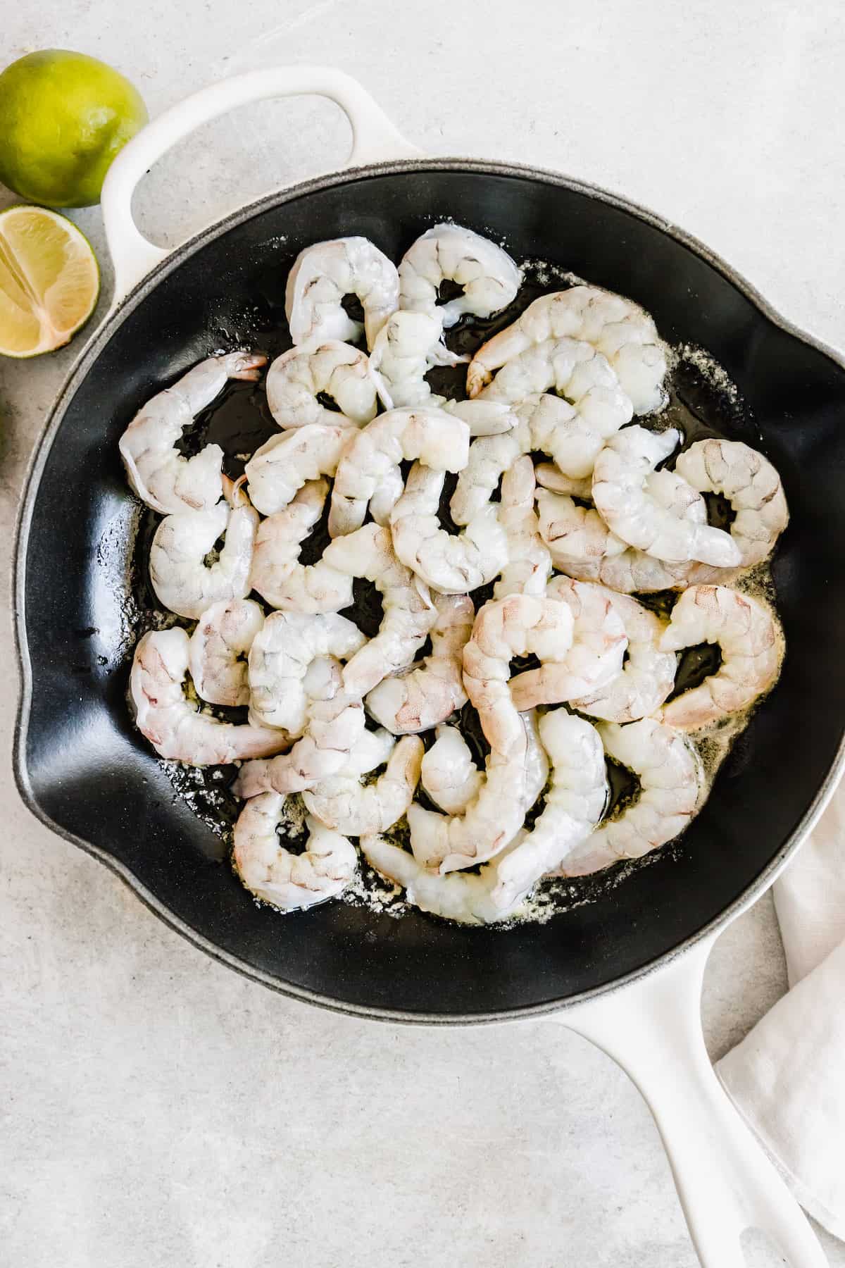 A Skillet on a Counter Containing Raw Shrimp