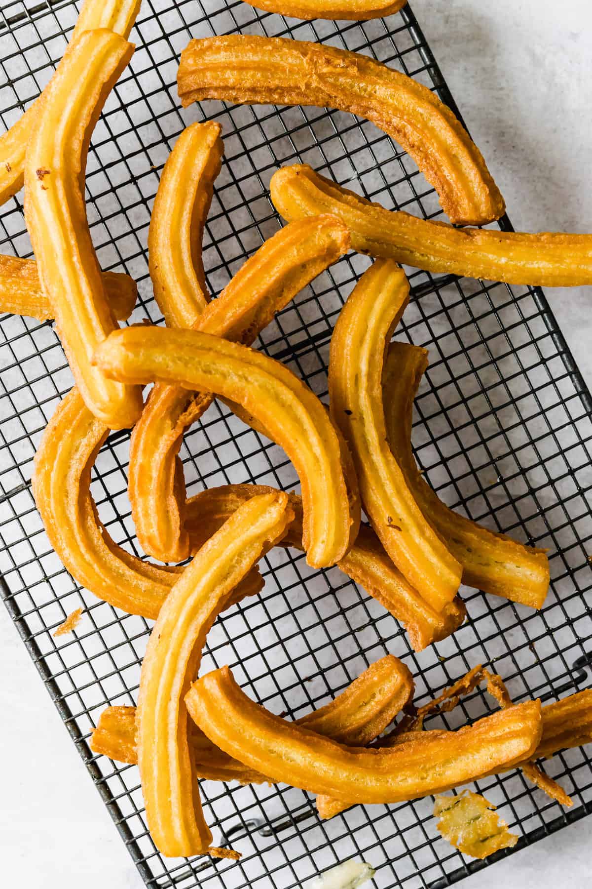 Sixteen Churros on a Wire Cooling Rack