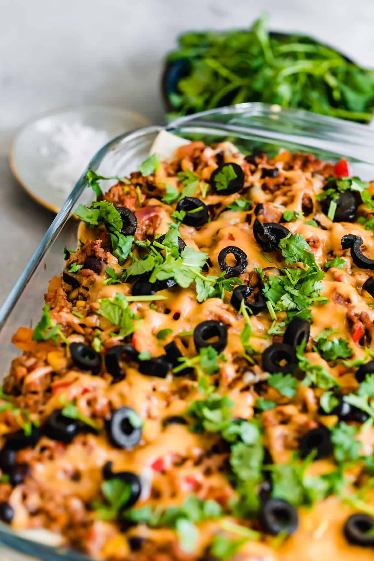 A Pan of Mexican Lasagna Topped with Chopped Parsley and Olives