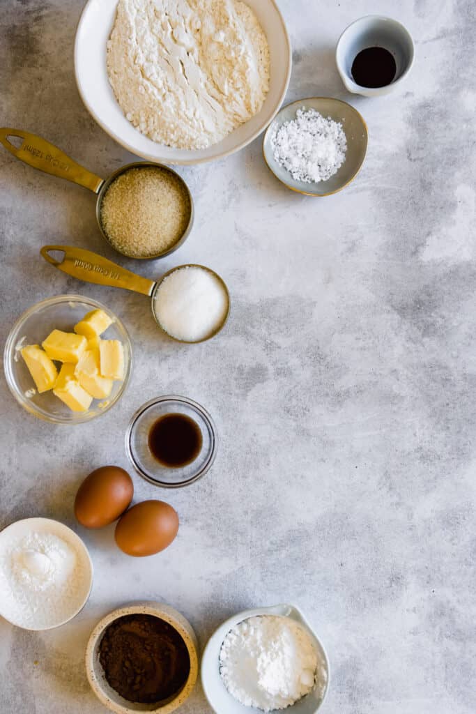 Eggs, Vanilla, Butter, Flour and the Remaining Cookie Ingredients on a Countertop