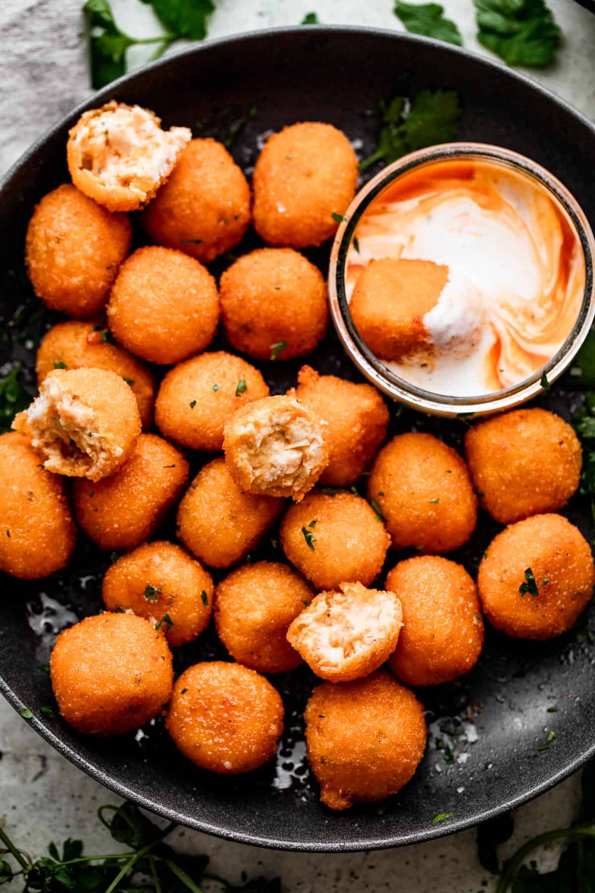Jalapeno Popper Balls in a black bowl with a Dipping Sauce