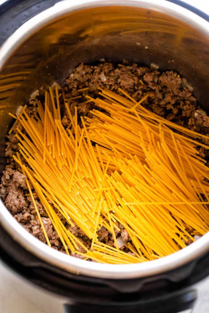 dry spaghetti set over ground beef in the instant pot
