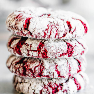 Four Crinkle Cookies Stacked on a Smooth White Surface