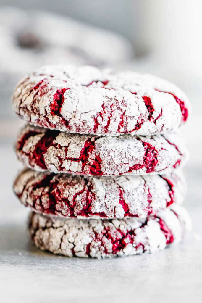 Four Crinkle Cookies Stacked on a Smooth White Surface
