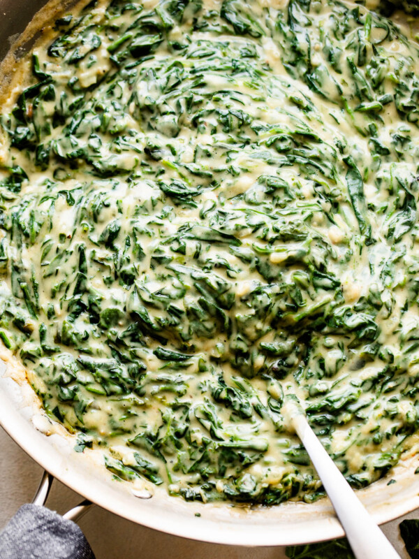 overhead picture of creamed spinach cooking in a large skillet