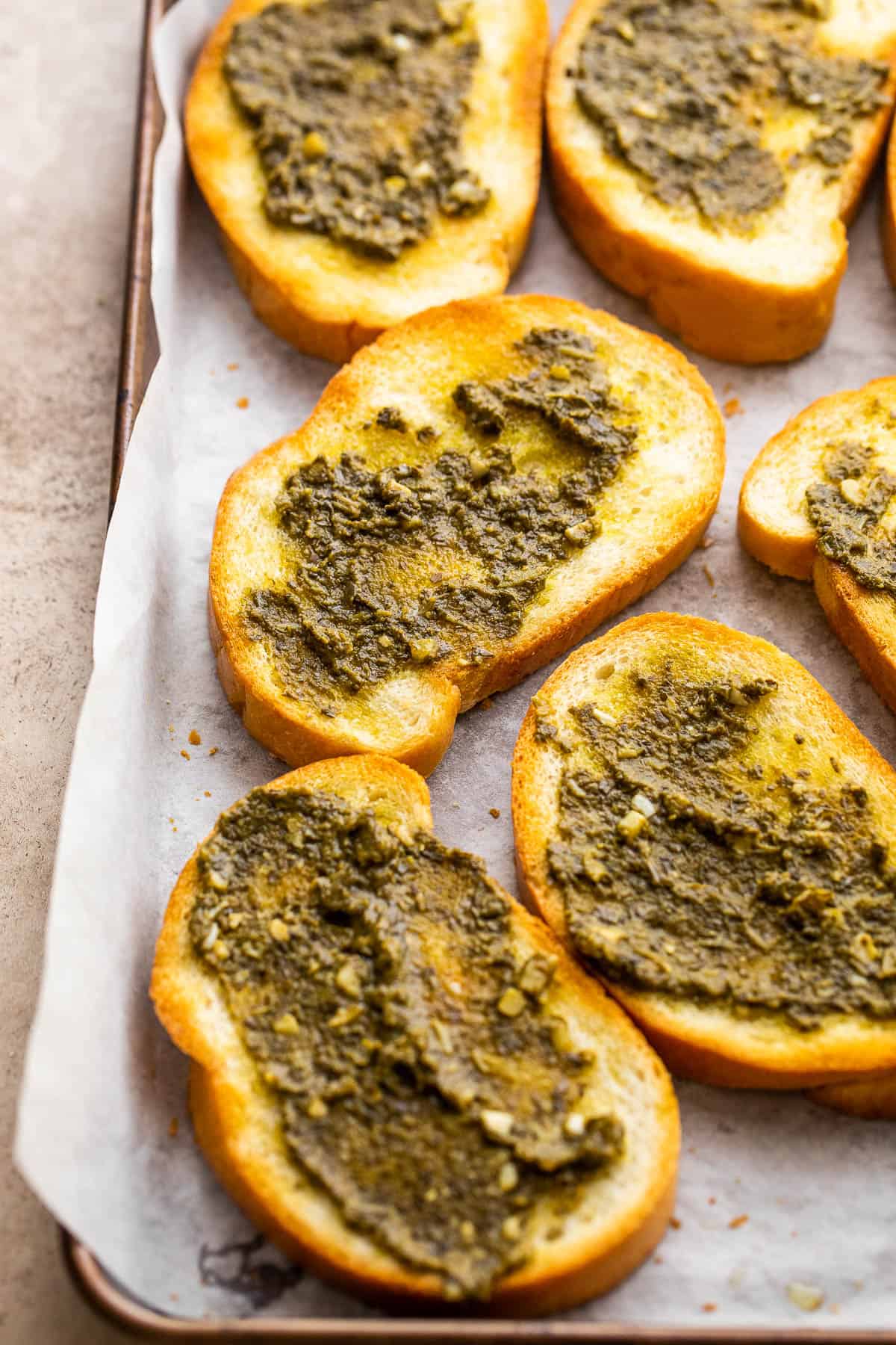 toasted bread slices topped with basil pesto