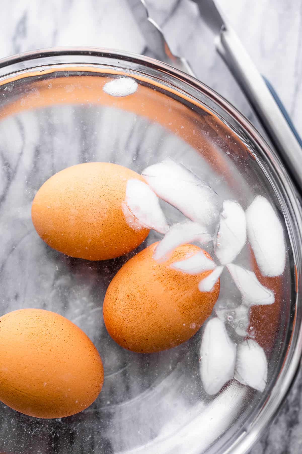 brown eggs cooling in ice bath