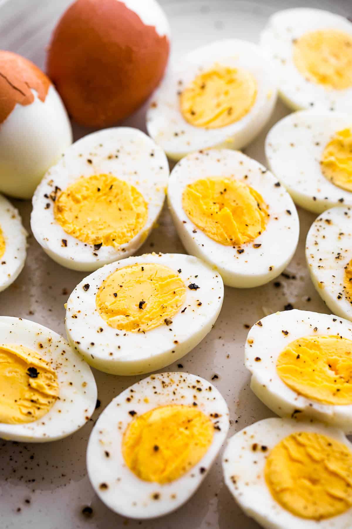 halved hard boiled eggs topped with cracked black pepper