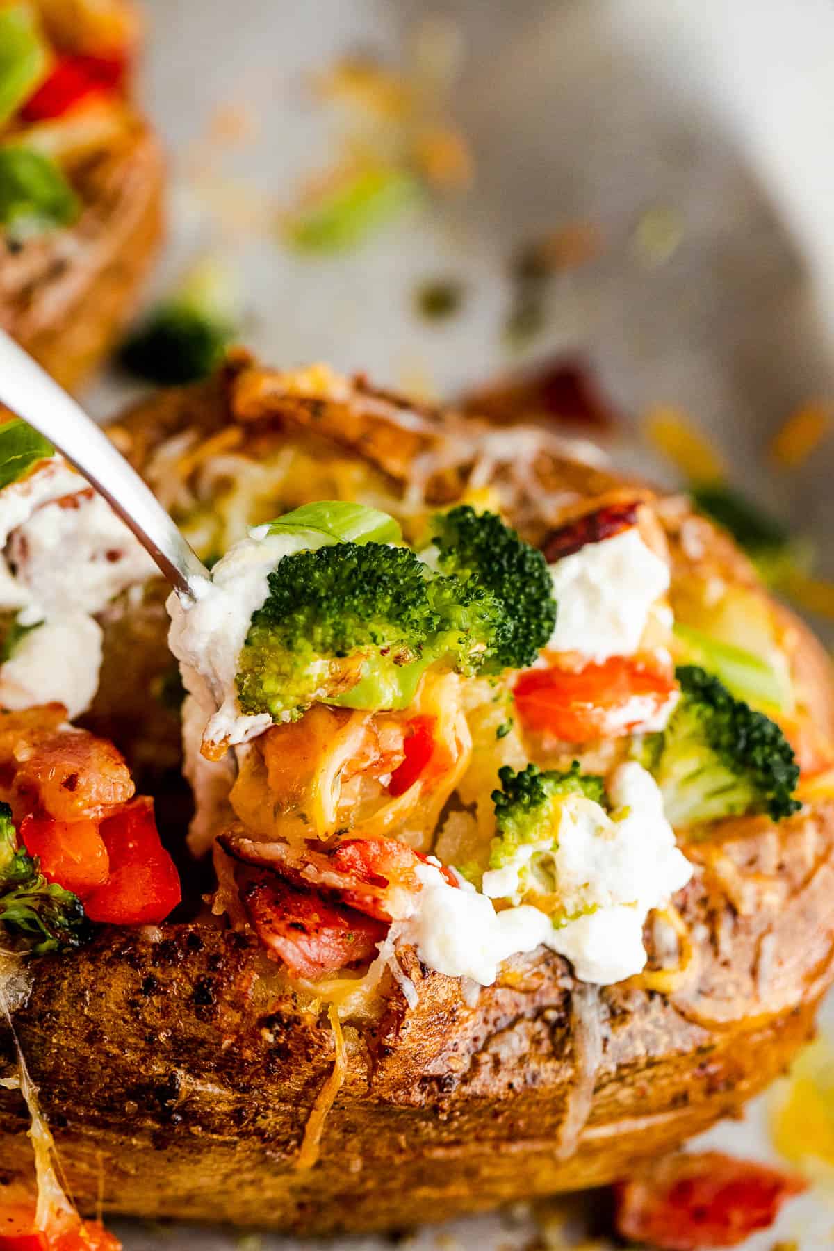 digging into a loaded baked potato with a fork