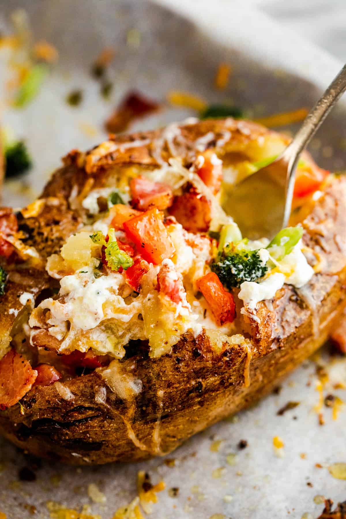 digging into a loaded baked potato with a fork