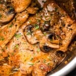 close up shot of pork chops in the instant pot topped with mushroom gravy sauce