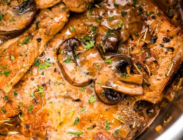 close up shot of pork chops in the instant pot topped with mushroom gravy sauce