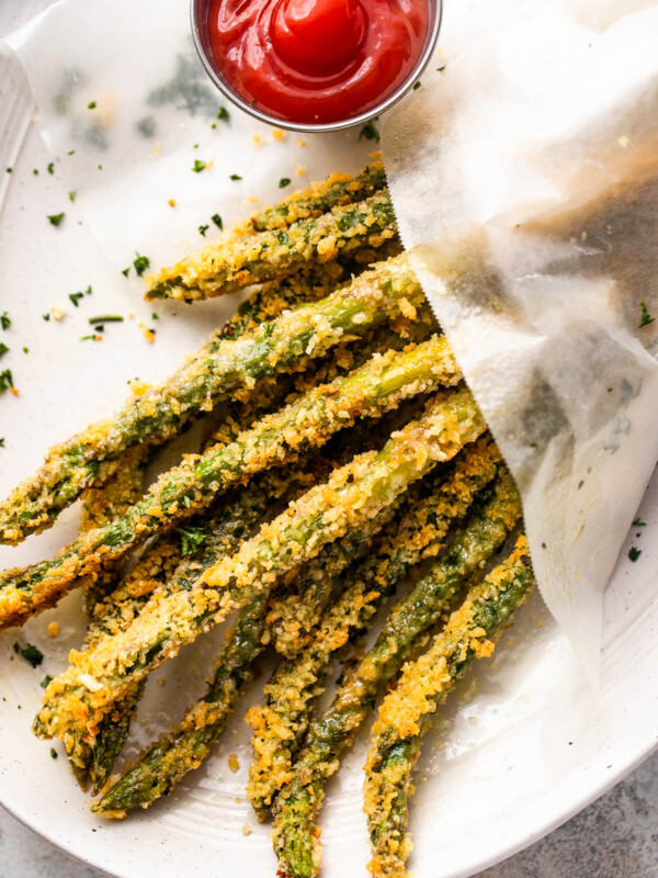 overhead shot of baked parmesan panko asparagus fries served with ketchup on the side