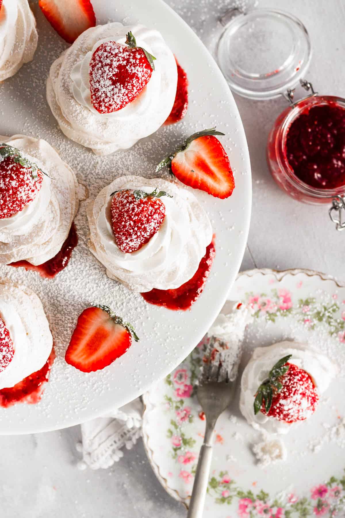 overhead shot of Pavlovas topped with strawberries and sugar