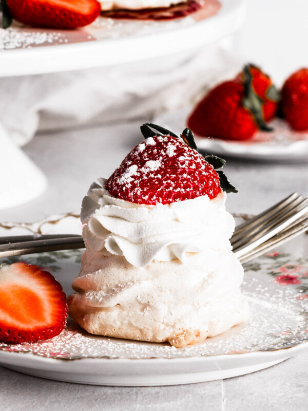 A mini pavlova on a plate with strawberries