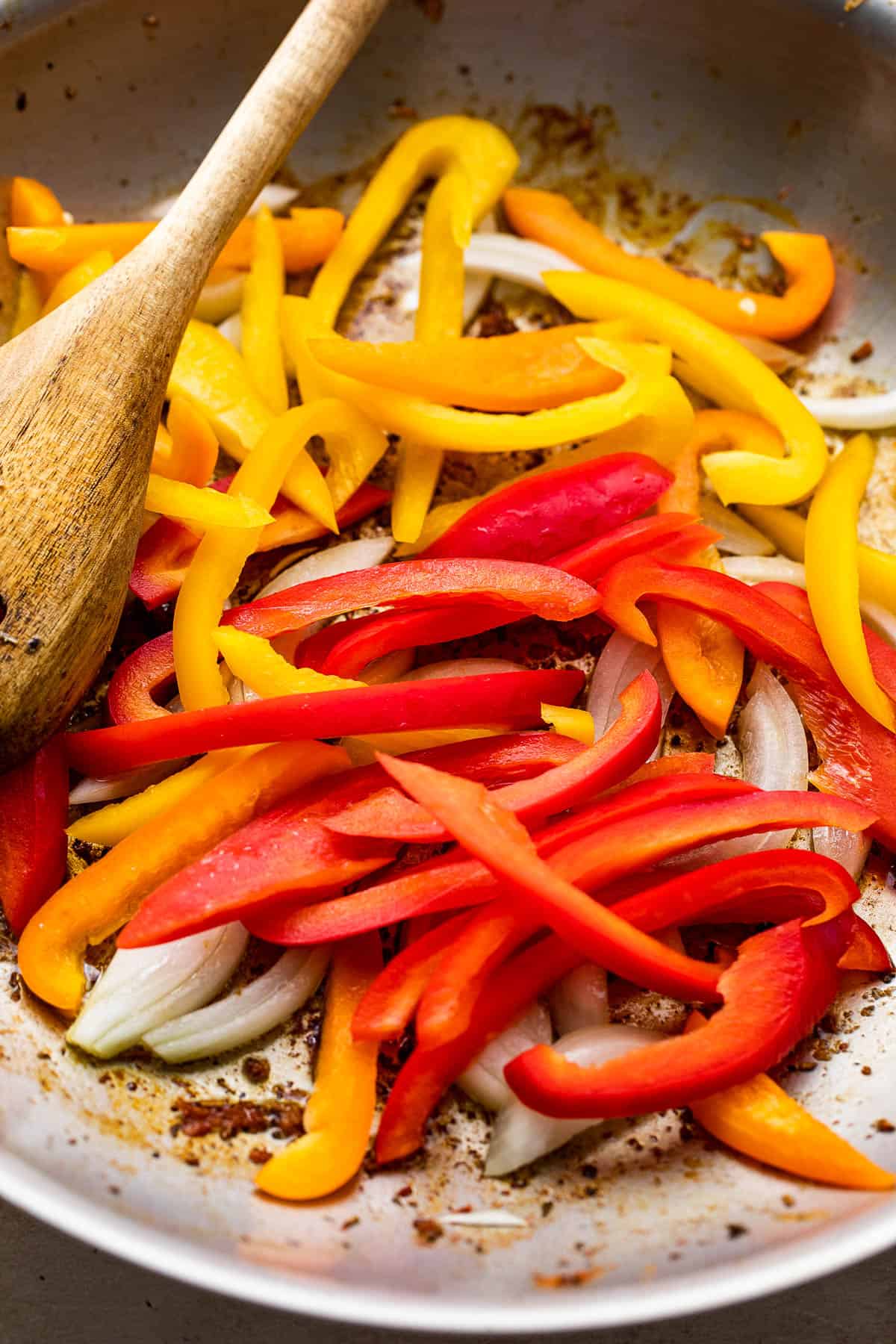 sauteeing bell pepper strips and onions in a skillet