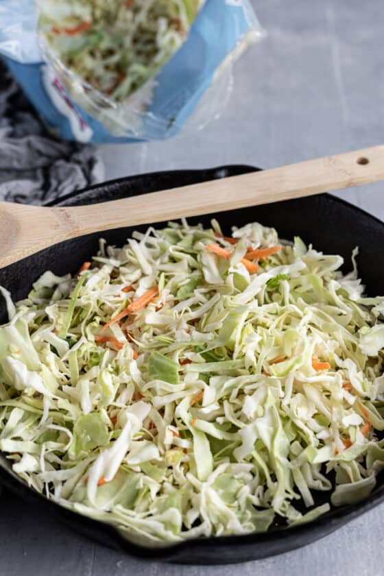 Cabbage Coleslaw in a Pan with a Wooden Spoon