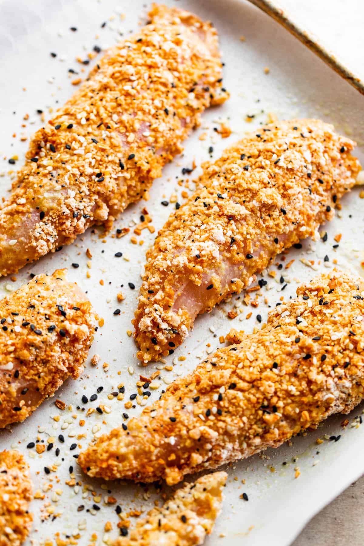 raw chicken tenders covered with everything bagel seasoning mix