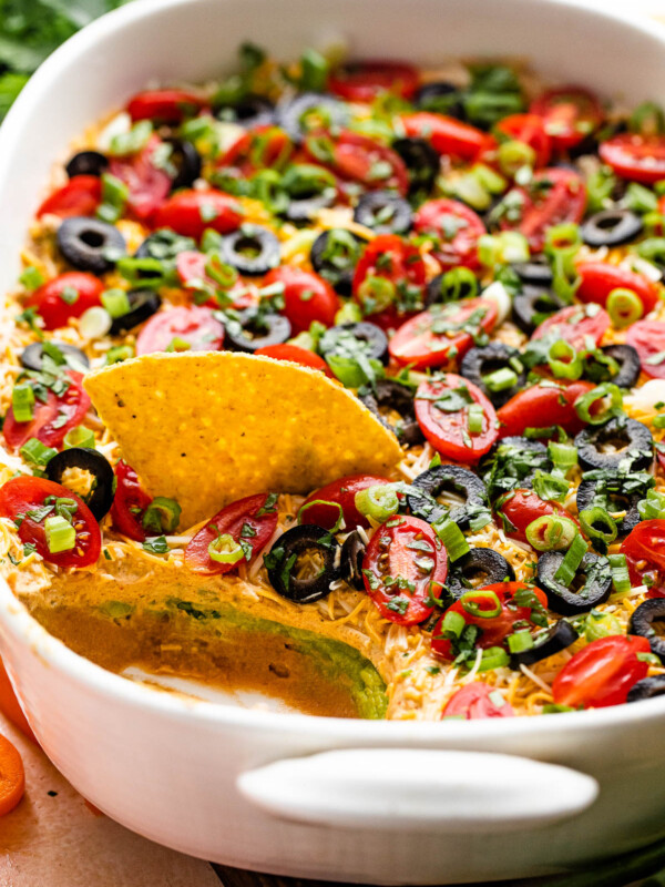 side shot of a white baking dish with seven layer mexican dip