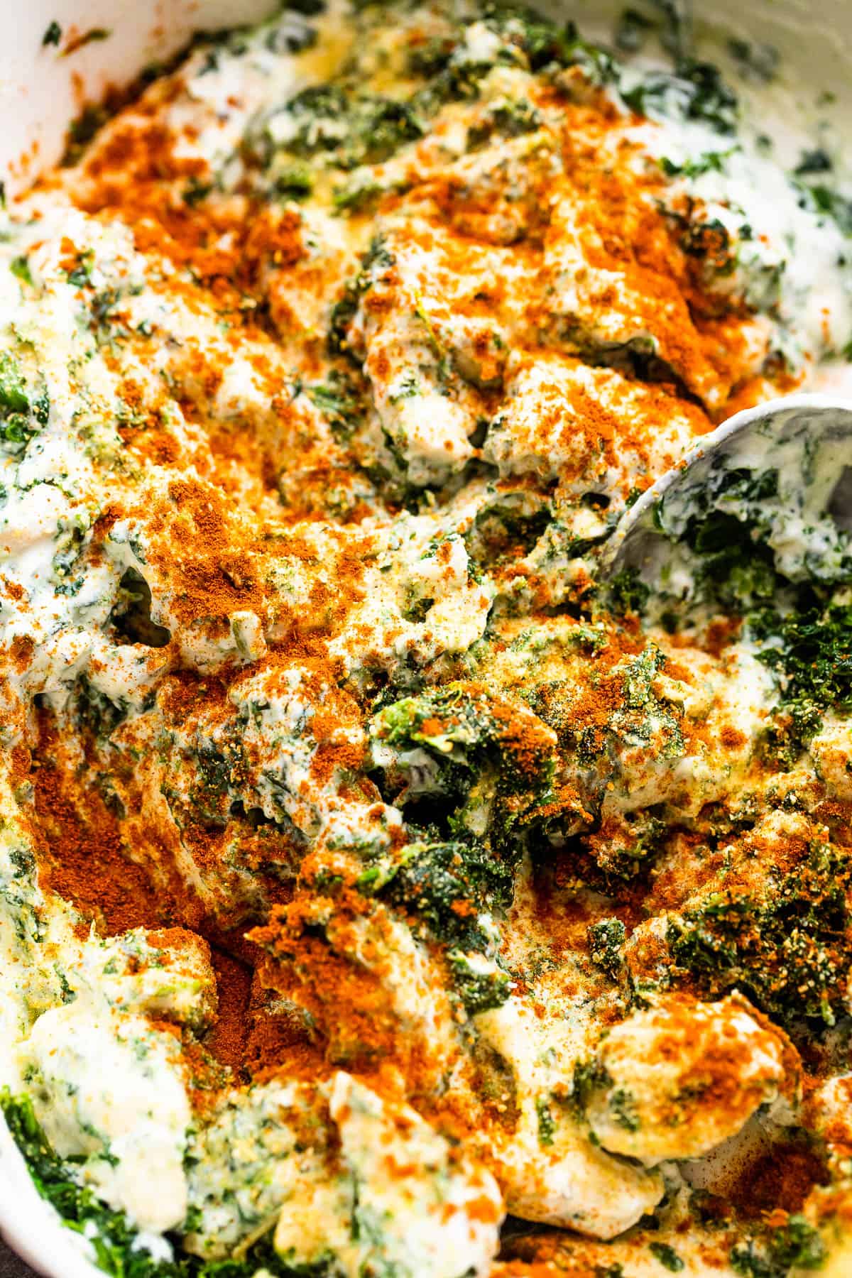 mixing chicken and spinach with sour cream and mayonnaise