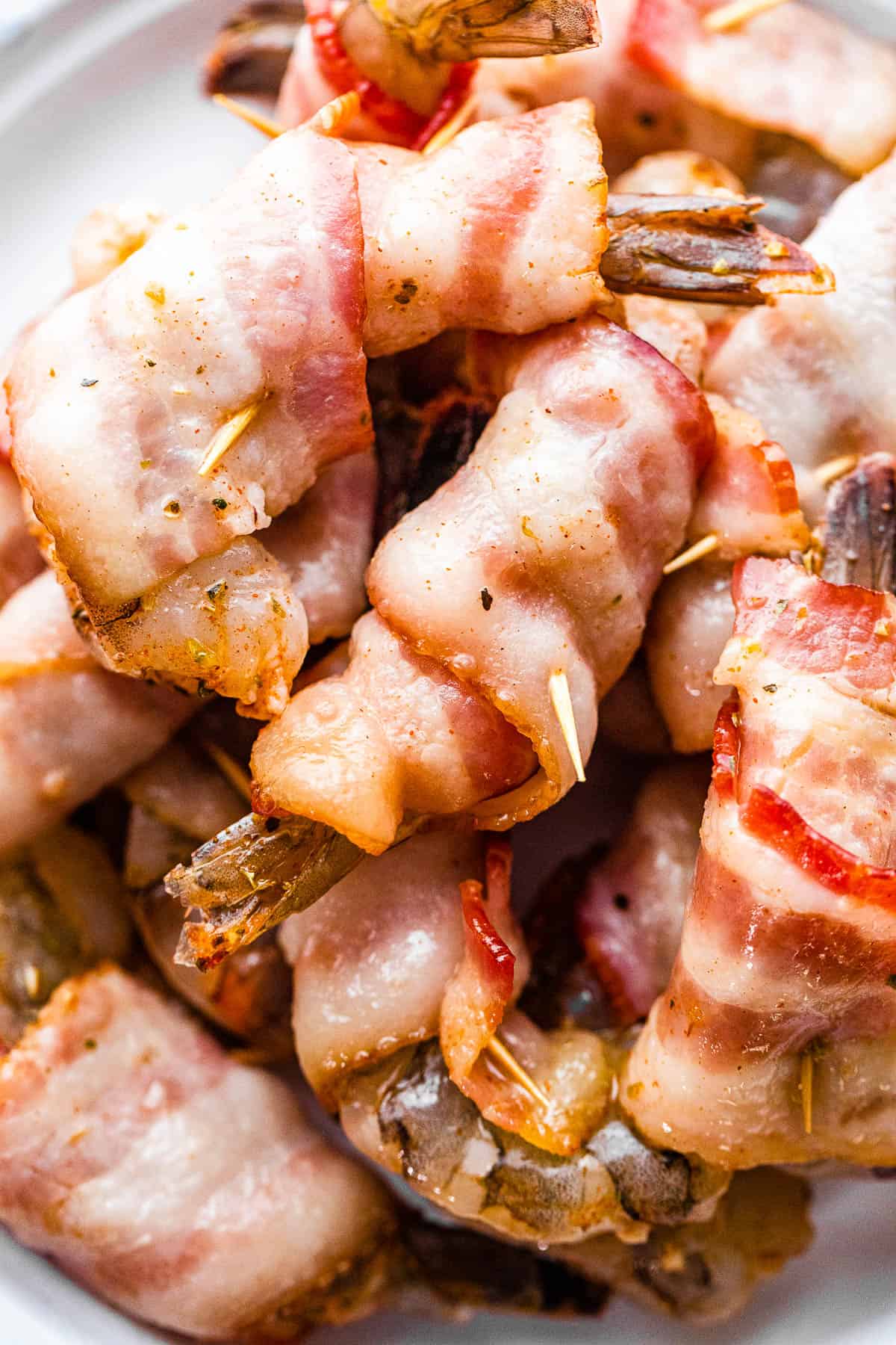raw shrimp wrapped in bacon and secured with toothpicks