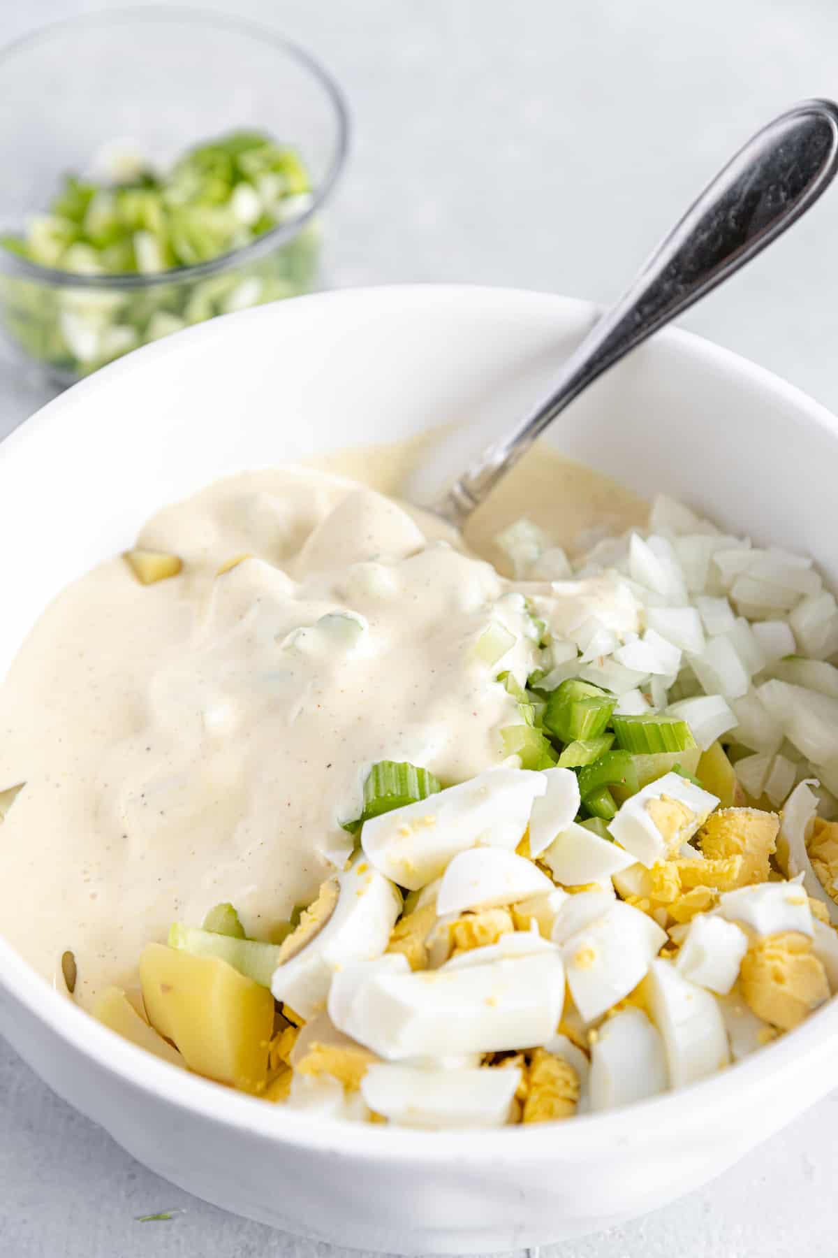 Mayonnaise Dressing Added Into the Bowl of Unmixed Potato Salad Ingredients