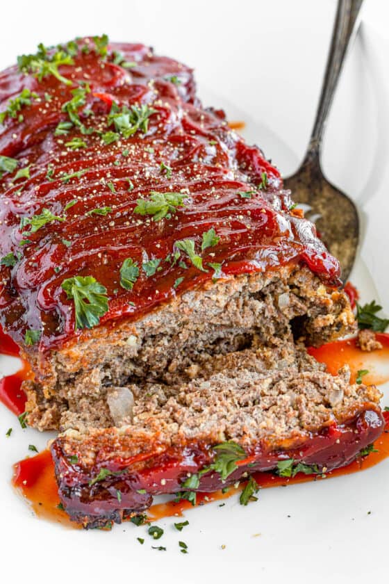 A Plate Full of Meatloaf with One Slice Removed