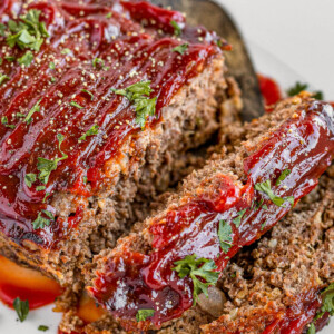 Meatloaf Covered in Barbecue Sauce on a White Serving Platter