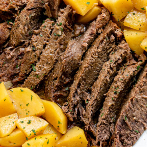 Pot roast with potatoes on a white plate