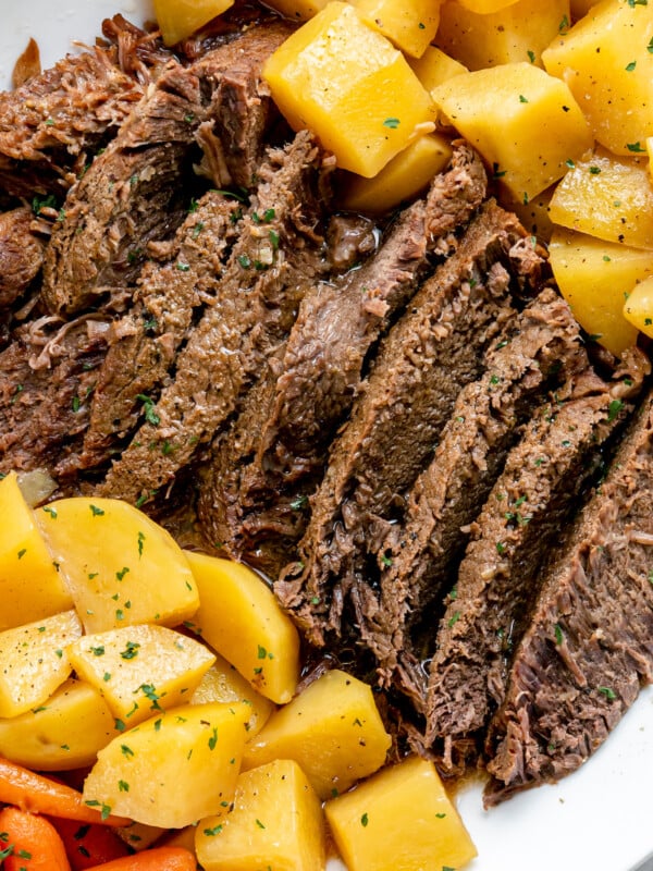 Pot roast with potatoes on a white plate