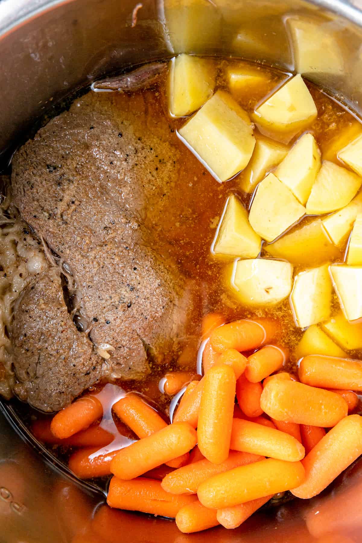 Steak, carrots and potatoes in broth