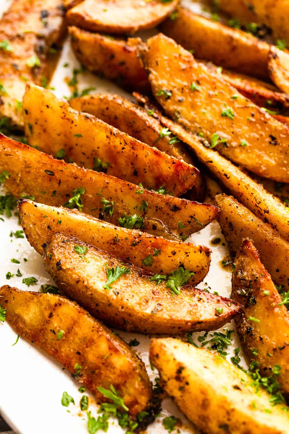 Grilled potato wedges served on a platter.