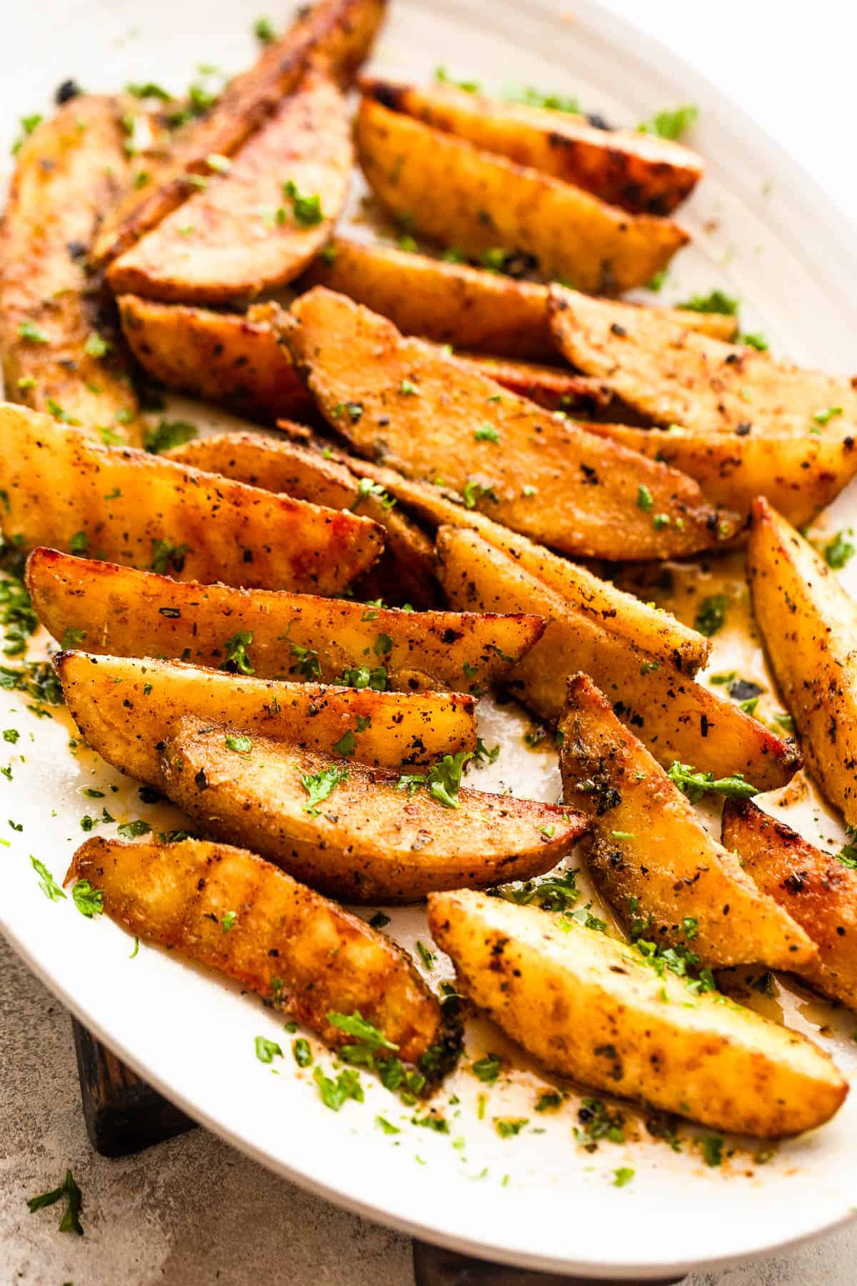 Sliced potatoes served on a white oval platter.