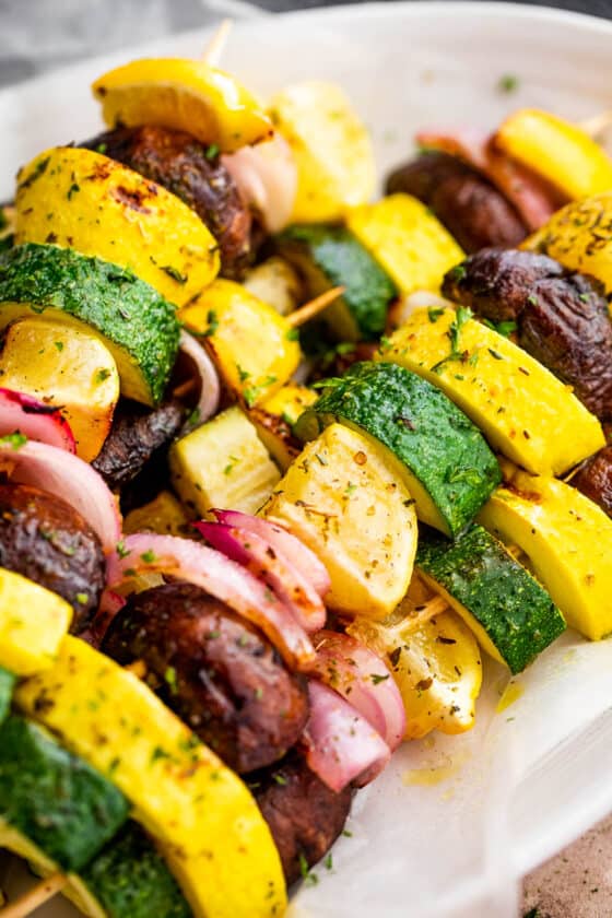 side shot of plated grilled squash skewers