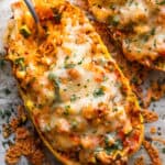 spaghetti squash stuffed with chicken enchilada filling and topped with melted cheese