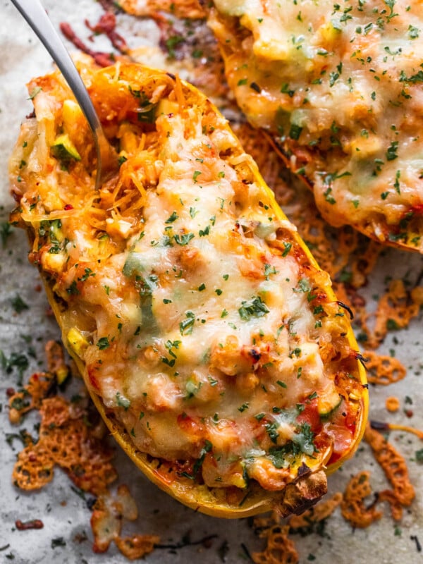 spaghetti squash stuffed with chicken enchilada filling and topped with melted cheese
