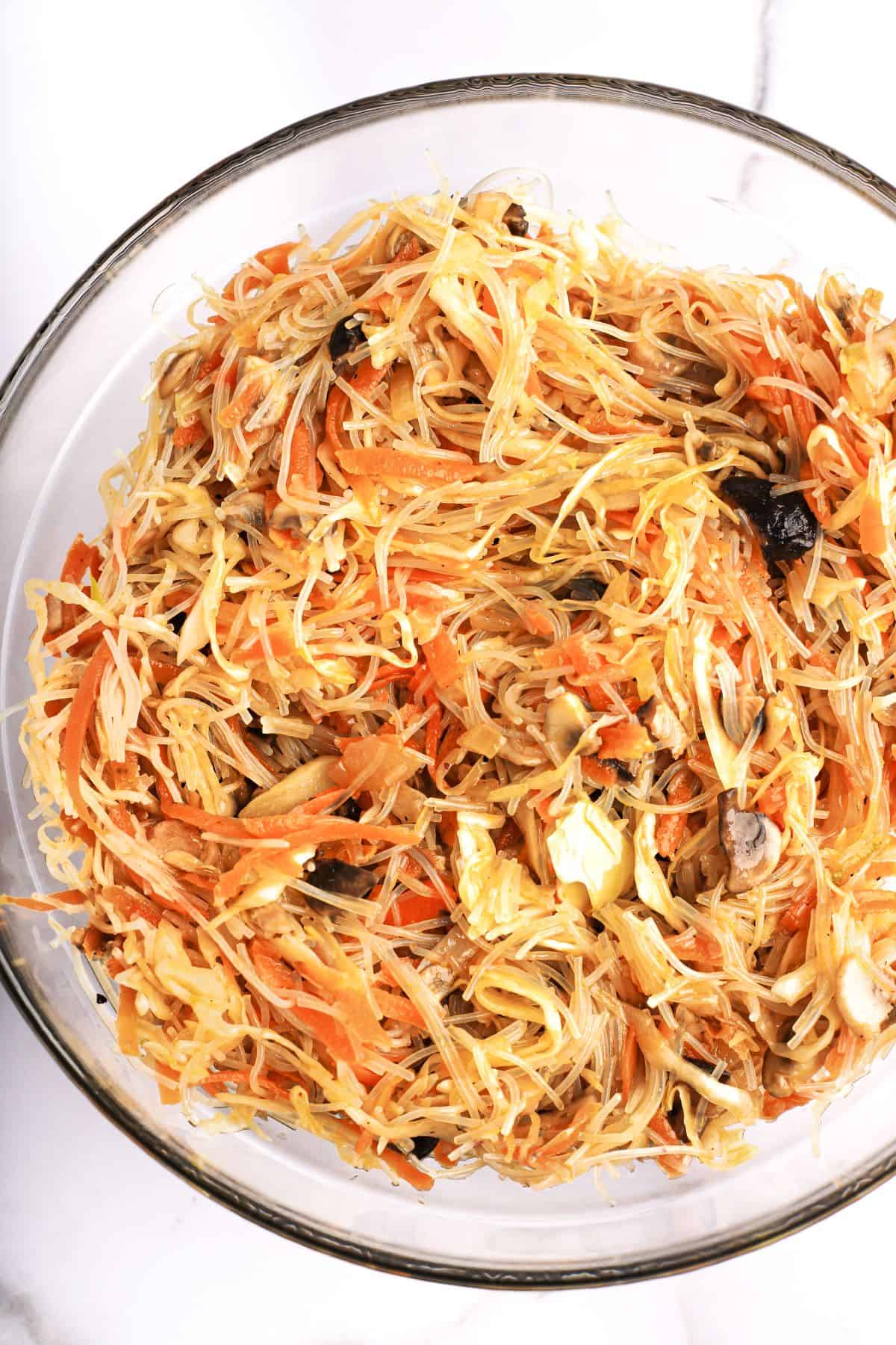 A bowl of spring roll filling, made with rice vermicelli, carrots, mushrooms, and more.