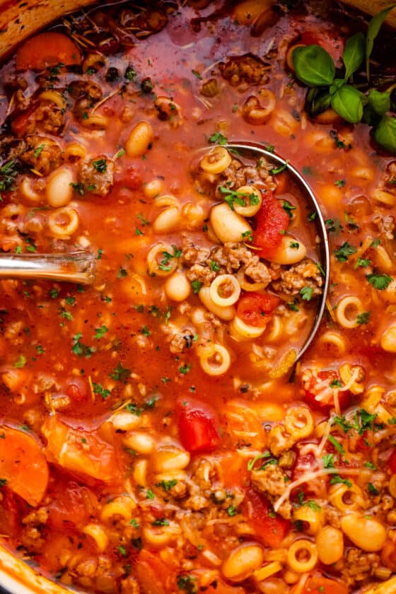 up close shot of a ladle spooning out pasta fagioli soup
