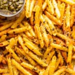close up of baked pasta chips served with basil pesto