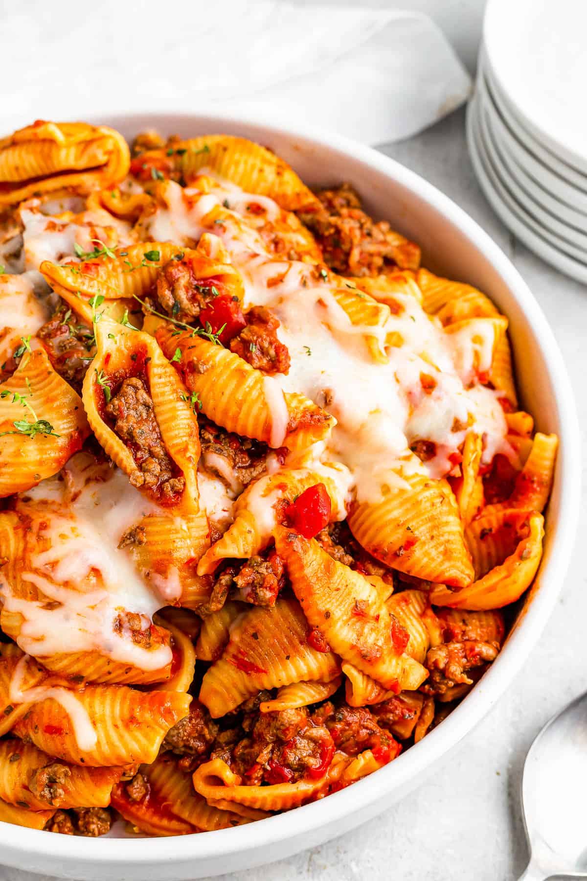 a serving of Instant Pot pasta shells and beef in tomato sauce, topped with melted mozzarella.
