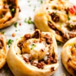 cooked taco pinwheels on a baking sheet.