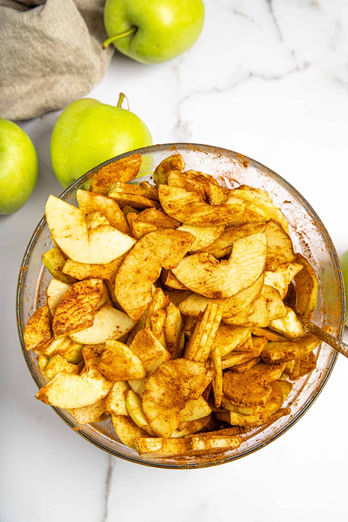 sliced apples coated with cornstarch, sugar, and spices