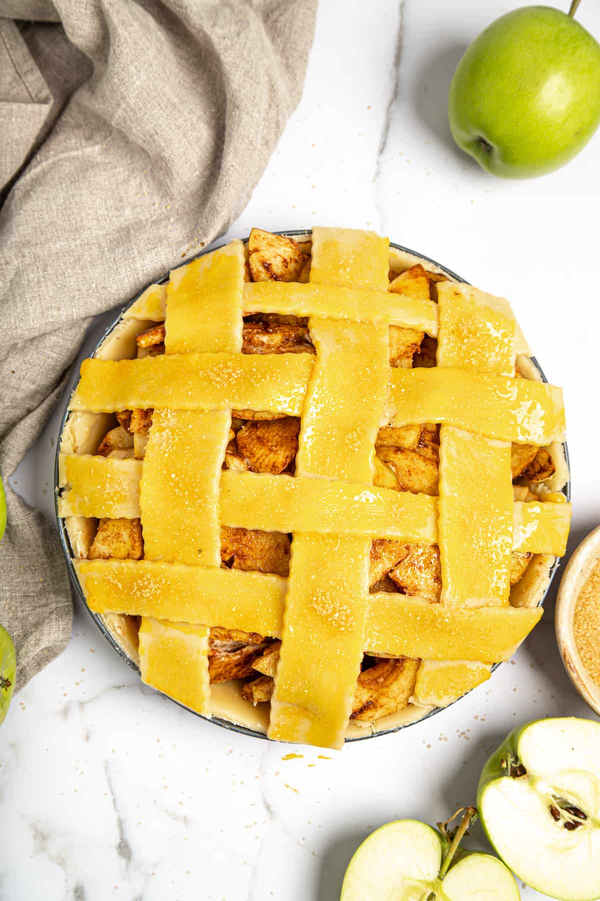 An unbaked apple pie with lattice top.