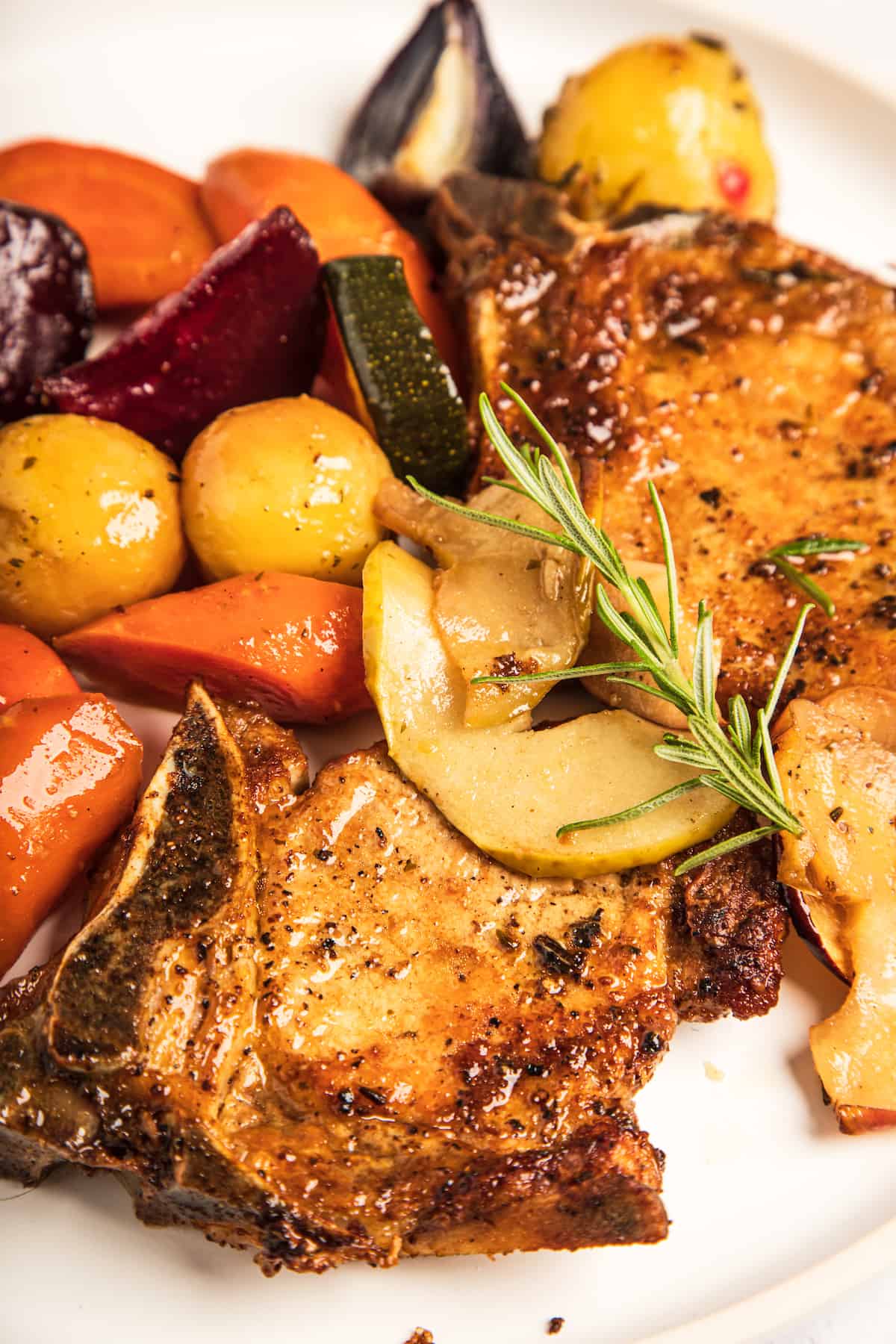 A close-up shot of the pork chops and mixed vegetables.