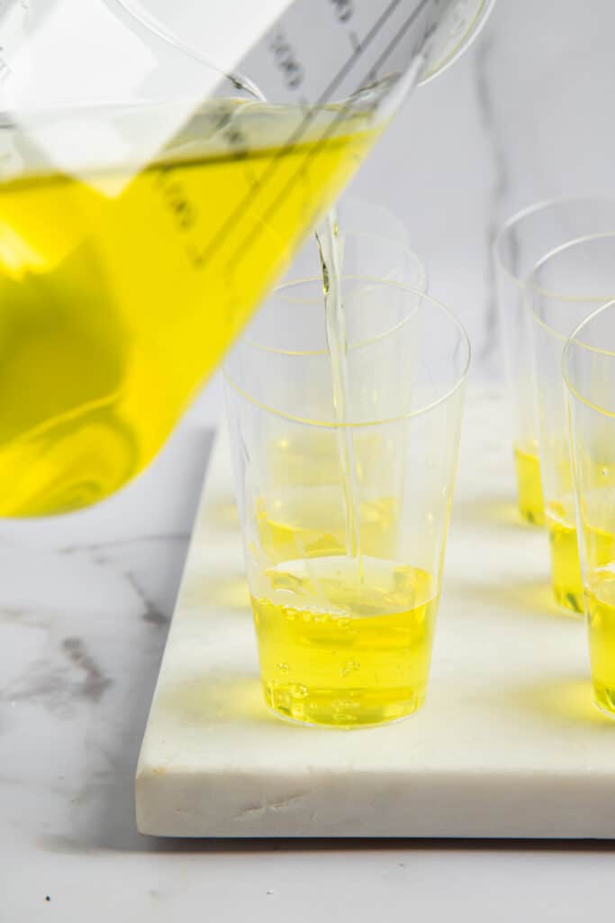 Lemon jello poured into shot glasses.